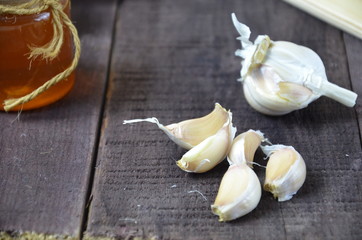 Garlic, lemon, ginger and honey, fresh and healthy food products, concept for healthy nutrition and strengthening immunity