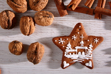 Gingerbread star poured white frosting on Christmas Eve table in a Christmas surprise for guests.
