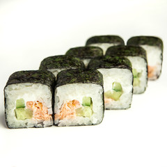 Japanese sushi rolls with soy sauce and chopsticks on a white background