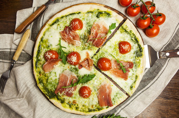 delicious Italian pizza on a napkin and dark wooden table