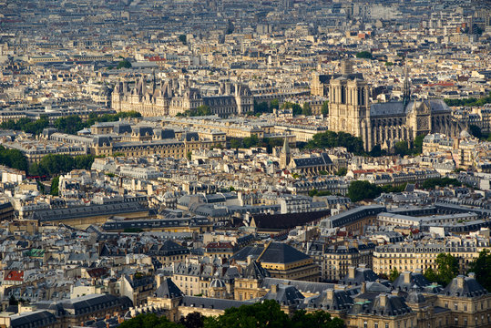 Aerial view on Paris rooftops at sunset with Notre Dame de Paris Cathedral. 4th (Latin Quarter) and 6th Arrondissment, Paris, France