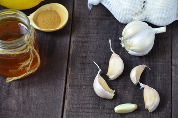 Garlic, lemon, ginger and honey, fresh and healthy food products, concept for healthy nutrition and strengthening immunity
