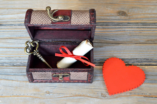 Valentines heart, love letter and key in wooden treasure chest