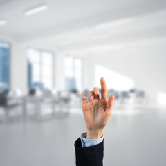 Choosing gesture of businessperson in elegant modern interior in sunshine light