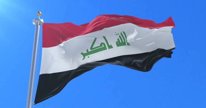 Flag of Iraq waving at wind in slow in blue sky, loop