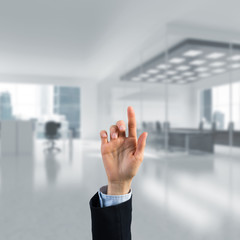 Choosing gesture of businessperson in elegant modern interior in sunshine light