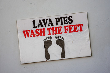 Sign saying "wash the feet" in a swimming pool, Huacachina, Ica, Peru