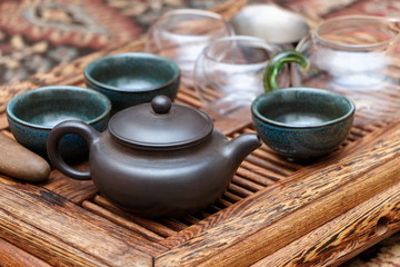 Kettle with cups on the table for the tea ceremony