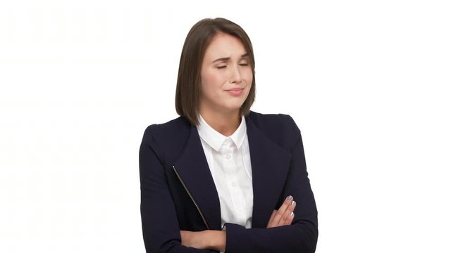 portrait of sarcastic young businesswoman wearing white blouse and black jacket standing with arms folded distrust disbelieve in what she hearing over white background. Concept of emotions