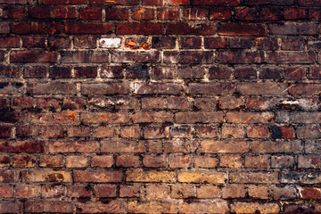 Old brown crumbling brick wall - vintage bright background