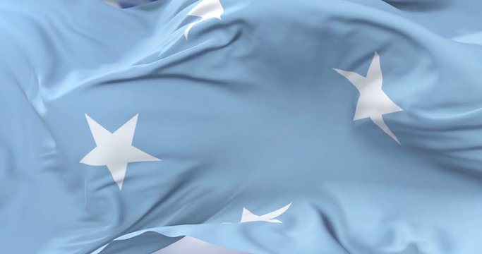 Flag of the Federated States of Micronesia waving at wind with blue sky in slow, loop