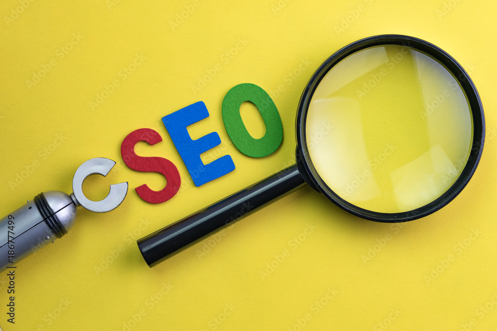 Poster magnifying glass, alphabet abbreviation seo and robot arm on vivid yellow background using as seo se