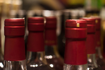 Fototapeta na wymiar red wine bottles in store