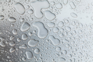 Metal surface covered in water drops.