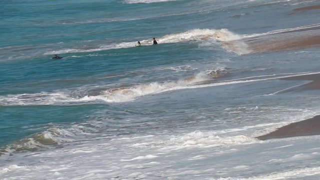 Guys surfing on El Palmar beach, on the coast of Cadiz, Andalusia, Spain