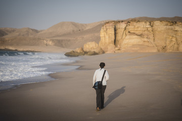 Woman Walking on a Beach