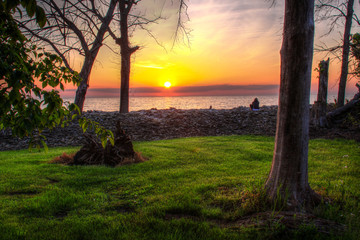 Sunset over Lake Erie on Kelley's Island with green grass and orange sky