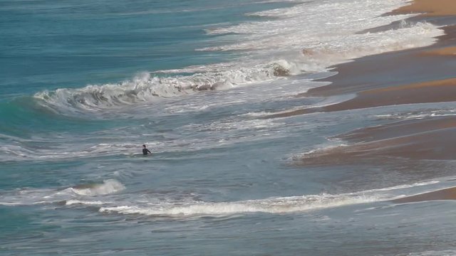 Guys surfing on El Palmar beach, on the coast of Cadiz, Andalusia, Spain