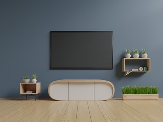 TV on the blue wall in modern living room in dark room,3d rendering