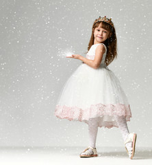 Young little girl model in the white communion  winter dress stands in gold crown with expensive gems © Dmitry Lobanov