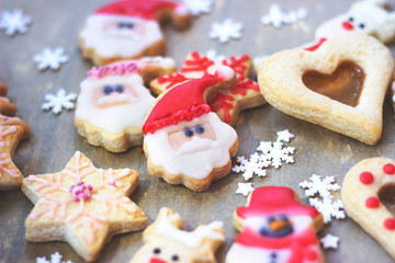Royal icing decorated christmas cookies on wooden background