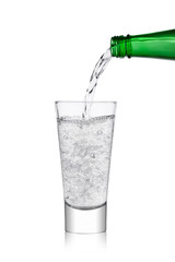 Pouring lemonade soda drink from bottle to glass