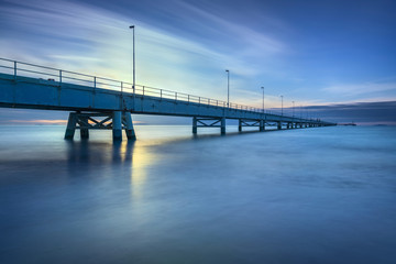 Fototapeta premium Industrial pier on the sea. Side view. Long exposure photography.