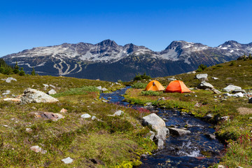 Summer is here which means it's camping season around the corner.  Scenic landscape of mountains and tents