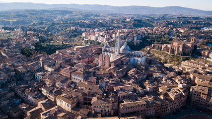 Aerial drone view of a cathedral in the Tuscan hillside town of Siena Italy