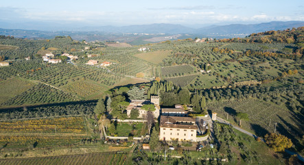 Fototapeta na wymiar Aerial drone view of a castle in the Tuscan hillside of Italy