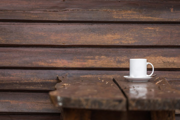 white coffee cup placed on a wooden table alone