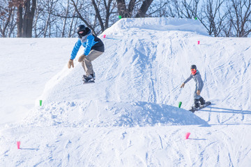 People are having fun in downhill skiing and snowboarding