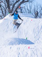 People are having fun in downhill skiing and snowboarding