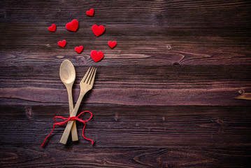 Dinner with table setting in rustic wood style with cutlery, red heart.  Valentine day.