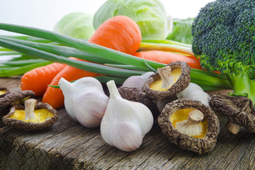 Organic vegetables, healthy food, fresh vegetables and ingredients on the table in the wood, mushrooms, garlic, etc.