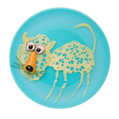 Leopard made with cheese and vegetables blue plate