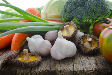 Organic vegetables, healthy food, fresh vegetables and ingredients on the table in the wood, mushrooms, garlic, etc.