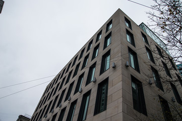 Office glass buildings on a cloudy sky background