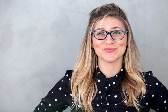 Quirky silly funny expression portrait of offbeat unfashionable woman in glasses