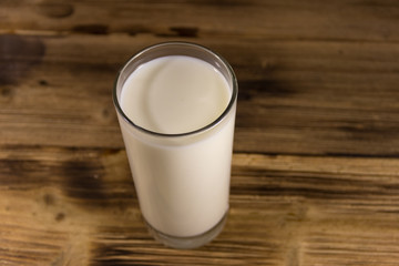 Glass of milk on wooden table
