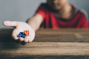 young boy showing dice