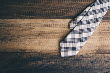 Fototapeta na wymiar tie / necktie on a wooden background. fashion concept. tie day