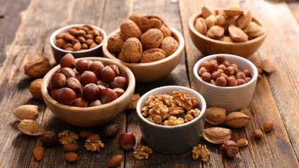 assorted nuts on wood background