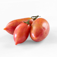 close up of 3 heirloom organic tomatoes on a white background