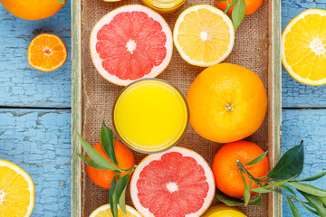 Different fruits and glass with fresh orange juice