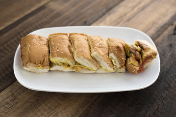 Malaysian delicacies (roti john) - bread with omelette in a plate on a wooden table