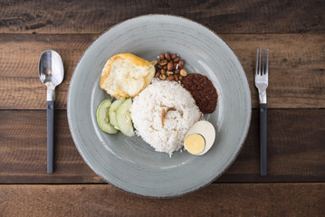 malaysian food/cuisine (nasi lemak) - white rice with fried egg,anchovies,spicy sauce (sambal) and...