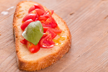Bruschetta bread with basil and chopped tomatoes. 