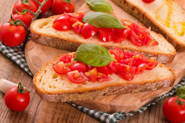 Bruschetta bread with basil and chopped tomatoes. 