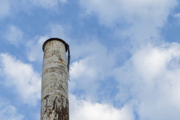 Old white chimney and rusty with blue sky background